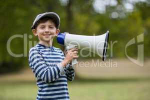 Smiling boy holding megaphone