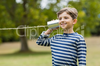 Boy listening through tin can phone