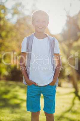 Smiling boy standing with hands in pocket