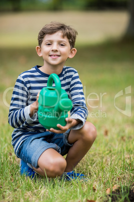 Boy holding a watering can