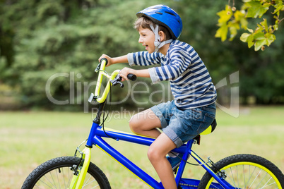 Smiling boy riding a bicycle