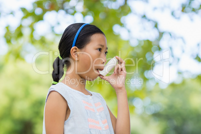 Girl using an asthma inhaler