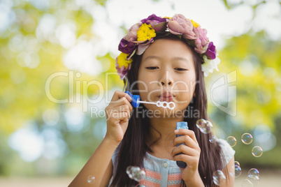 Girl blowing bubble wand