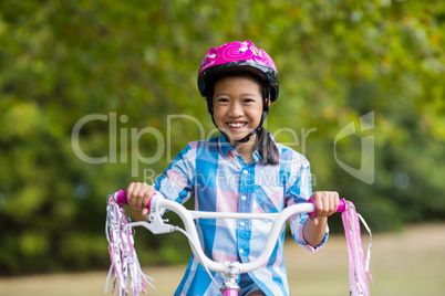 Portrait of smiling girl riding a bicycle