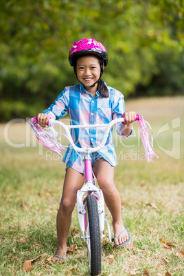 Portrait of smiling girl riding a bicycle