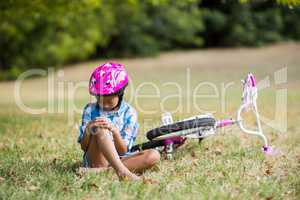 Young girl getting injured after fallen from bicycle