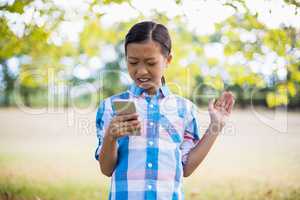 Girl using mobile phone in park