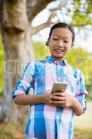 Smiling girl using mobile phone