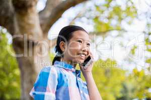 Smiling girl talking on mobile phone