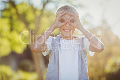 Portrait of young boy smiling in park