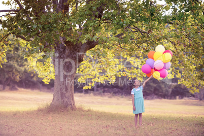 Girl holding a balloon in park