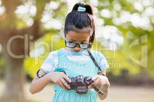 Young girl checking a photograph in camera