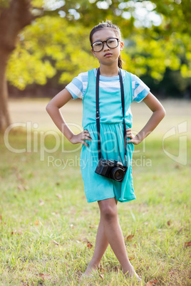 Portrait of girl standing with hand on hip