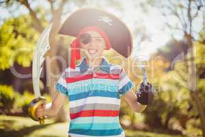 Portrait of boy pretending to be a pirate in the park