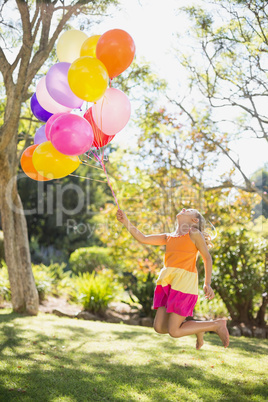 Girl playing with balloons in the park