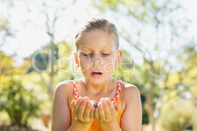 Girl holding petals in park