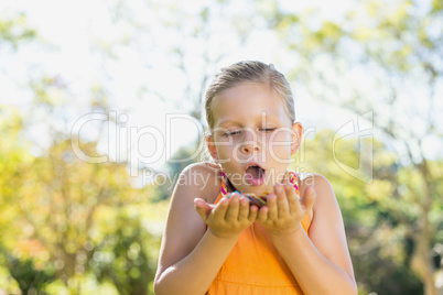 Girl holding petals in park