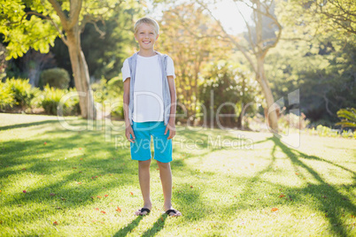 Portrait of smiling boy standing in park