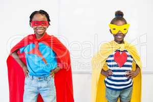 Smiling boy and girl pretending to be a superhero