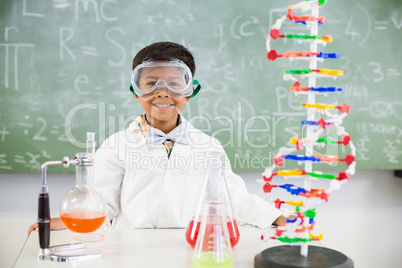 Portrait of schoolboy doing a chemical experiment in laboratory