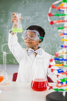 Schoolboy doing a chemical experiment in laboratory