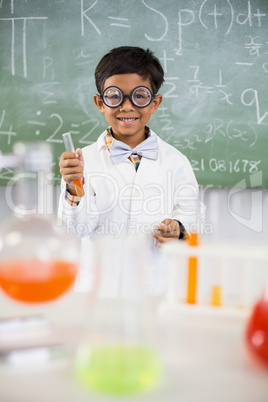 Schoolboy doing a chemical experiment in laboratory