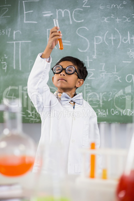 Schoolboy doing a chemical experiment in laboratory Schoolboy doing a chemical experiment in laboratory