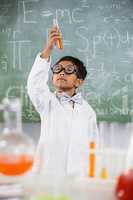 Schoolboy doing a chemical experiment in laboratory