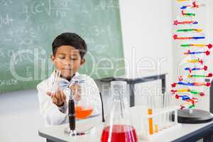 Schoolboy doing a chemical experiment in laboratory