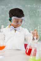 Schoolboy doing a chemical experiment in laboratory