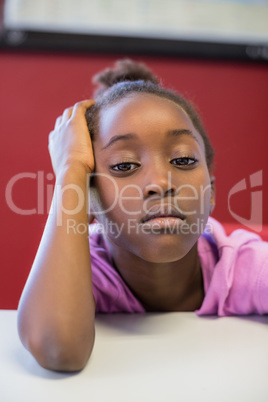 Upset girl sitting in classroom