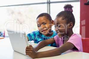 School kids using a digital tablet in classroom