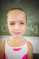 Portrait of happy schoolgirl smiling in classroom