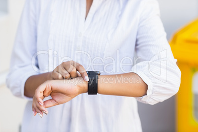 Woman checking a time in classroom