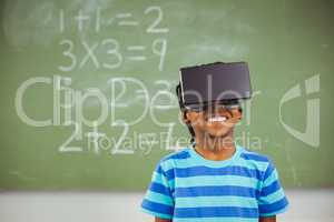 School boy in virtual reality glasses in classroom