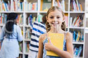 Girl holding a book in library