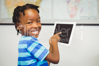 Portrait of school boy using a digital tablet in classroom