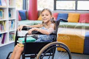 Disabled school girl with books in library
