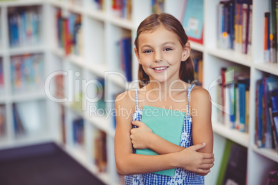 Girl holding a book in library
