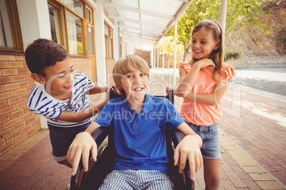 School kids talking to a boy on wheelchair