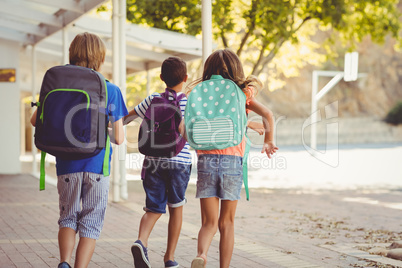 Happy school kids running in corridor