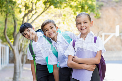 Portrait of smiling school kids standing in campus