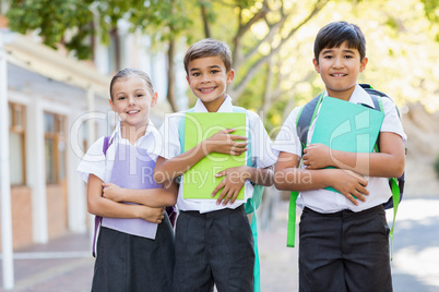 Portrait of smiling school kids standing in campus