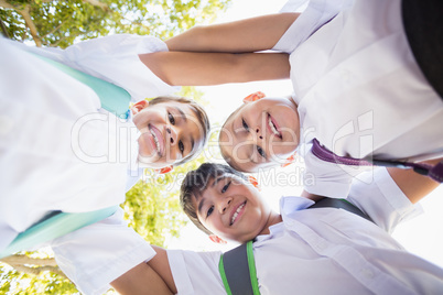 School kids forming huddle in campus