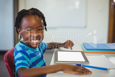 Happy schoolboy with digital tablet in classroom Happy schoolboy with digital tablet in classroom