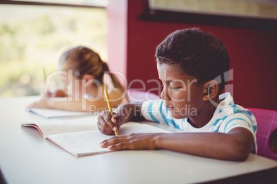 School kids doing homework in classroom