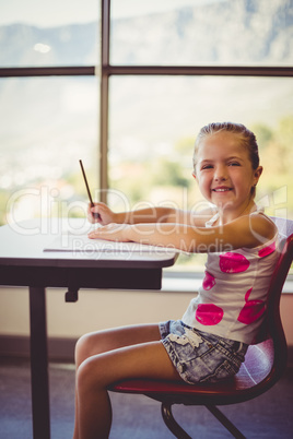 Girl doing homework in classroom