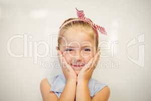 Portrait of cute girl posing at camera in classroom