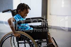 Schoolboy sitting on wheelchair