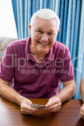 Senior man playing cards